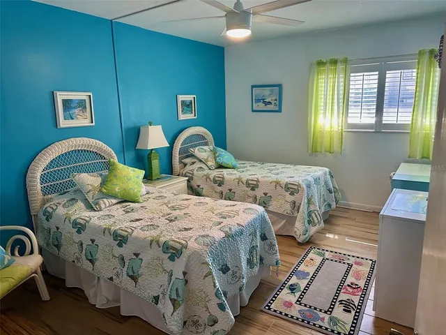 a bedroom with two beds and painting on the wall