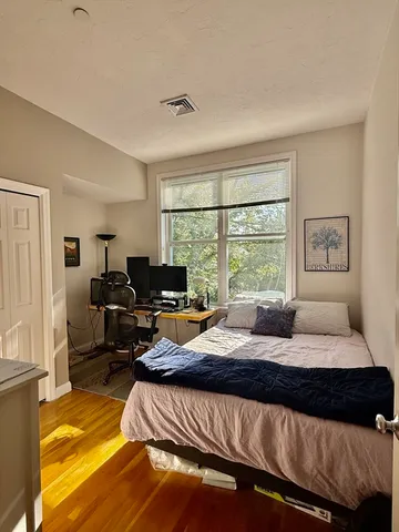 a bedroom with a bed and glass window