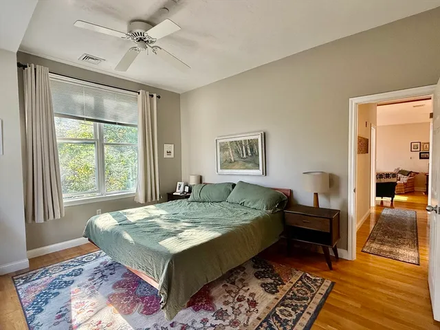 a living room with a bed and rug