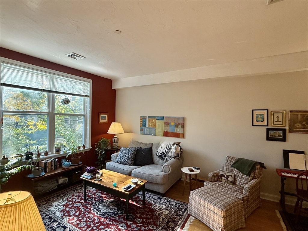 253 Norfolk Street, Unit 22 Cambridge, MA 02139 - Photo 8 of 20 a living room with furniture and a window