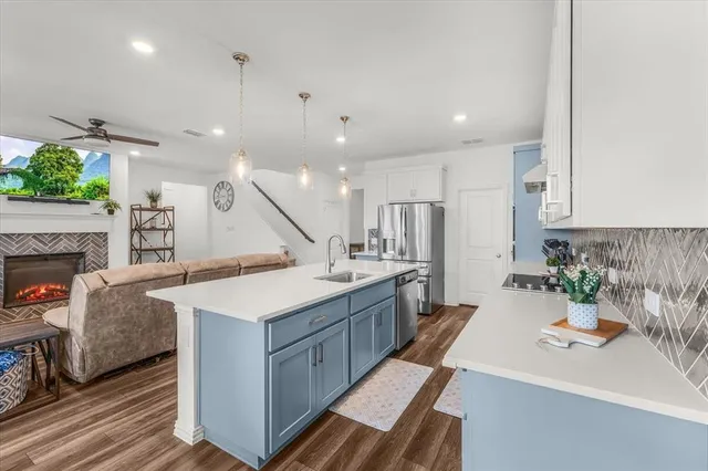 a large kitchen with cabinets a sink and a stove