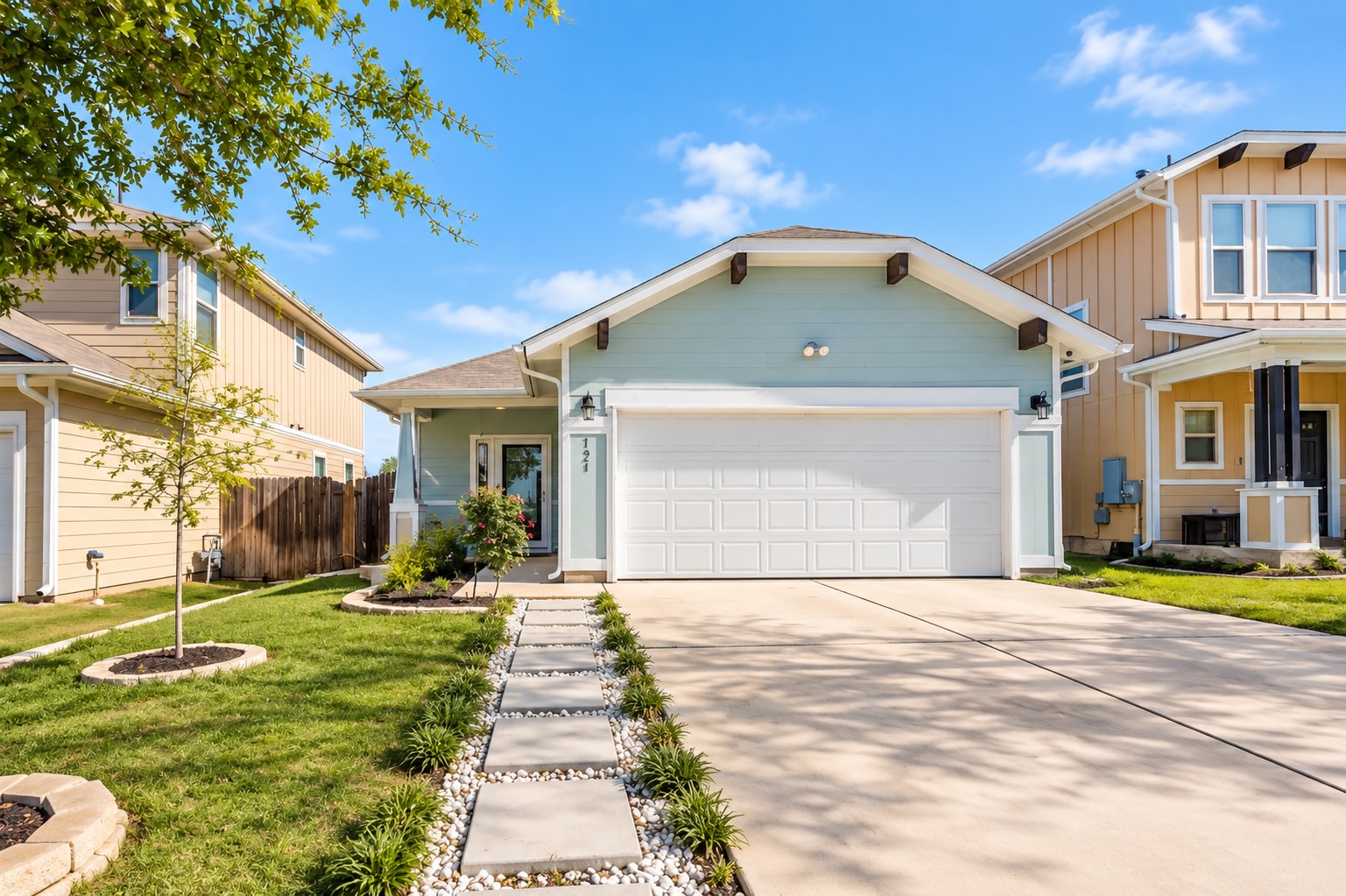 121 Guemal Road Buda, TX 78610 - Photo 1 of 13 Welcoming front exterior showcases clean architectural lines, a tidy lawn, and a spacious paved driveway.