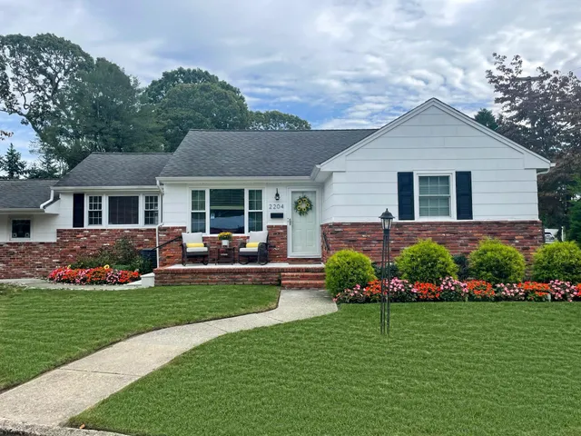 a front view of house with yard and green space