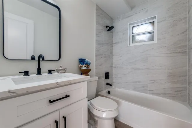 a bathroom with a sink a toilet and a bathtub