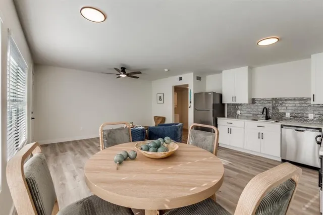 a kitchen with stainless steel appliances kitchen island granite countertop a sink and cabinets