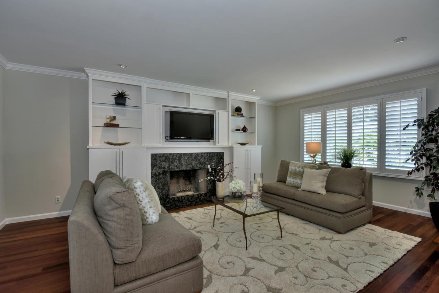1031 Suffolk Way Los Altos, CA 94024 - Photo 6 of 26 a living room with furniture a flat screen tv and a fireplace