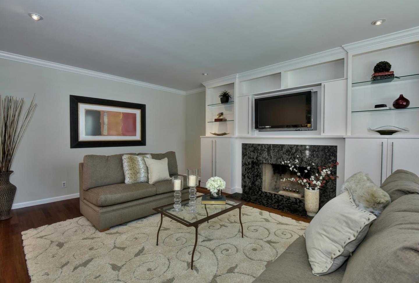 1031 Suffolk Way Los Altos, CA 94024 - Photo 7 of 26 a living room with furniture a fireplace and a flat screen tv