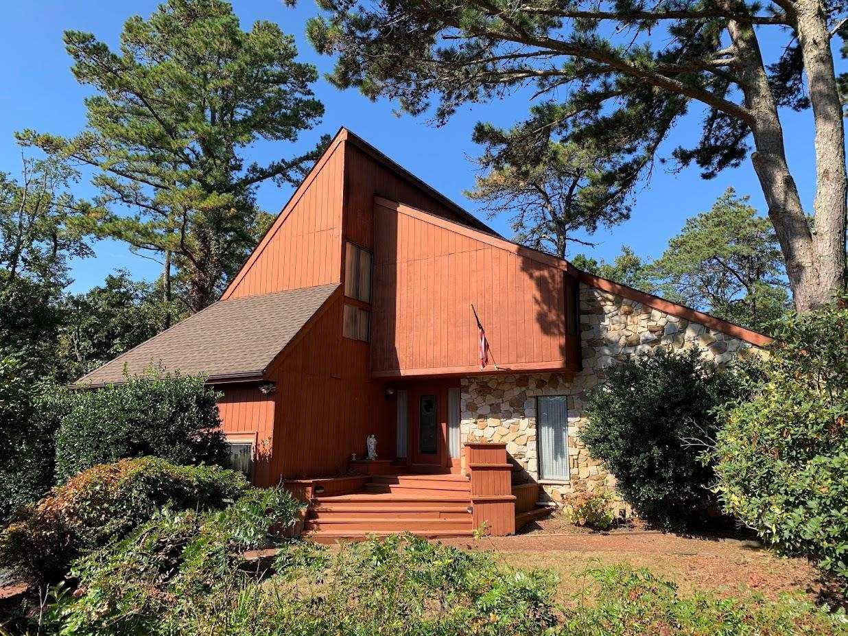 a view of a house with a tree in the background