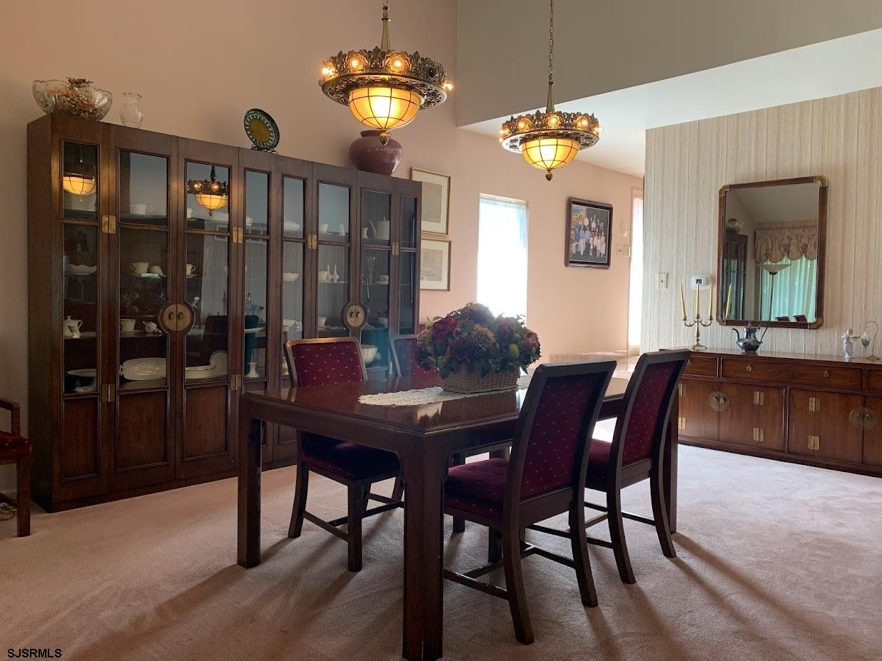 16 Greenbriar Road Marmora, NJ 08223 - Photo 13 of 37 a view of a dining room with furniture wooden floor and chandelier