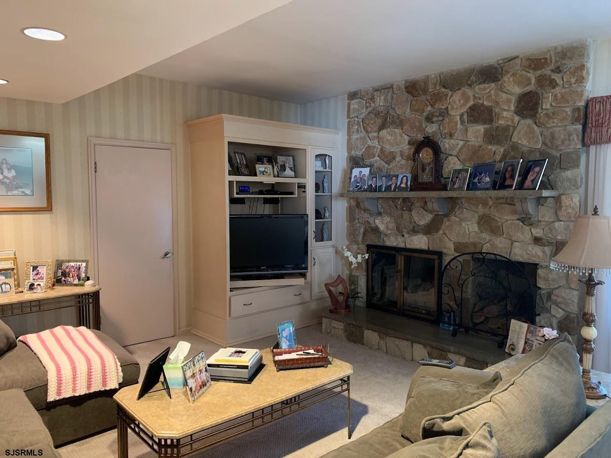 16 Greenbriar Road Marmora, NJ 08223 - Photo 15 of 37 a living room with furniture and a fireplace