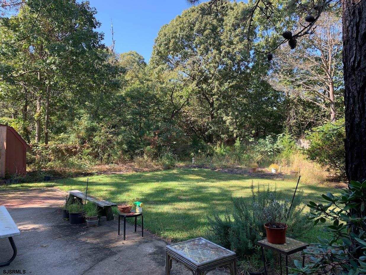 16 Greenbriar Road Marmora, NJ 08223 - Photo 20 of 37 a backyard of a house with table and chairs