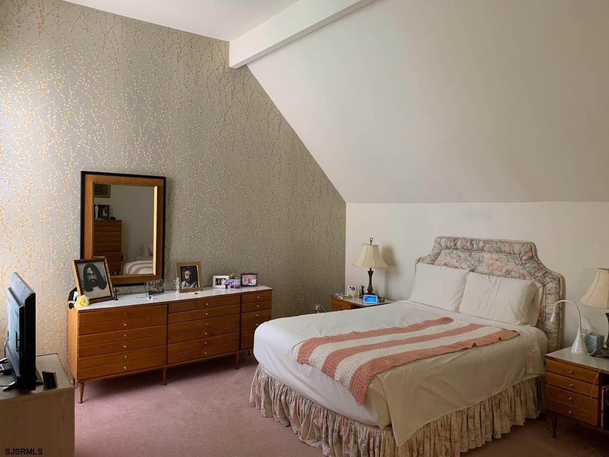 16 Greenbriar Road Marmora, NJ 08223 - Photo 24 of 37 a bedroom with a bed and a flat tv screen on the dresser