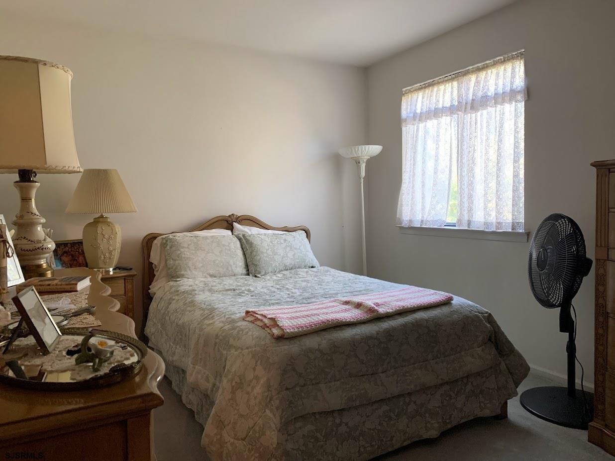 16 Greenbriar Road Marmora, NJ 08223 - Photo 27 of 37 a bedroom with a bed a mirror and dresser