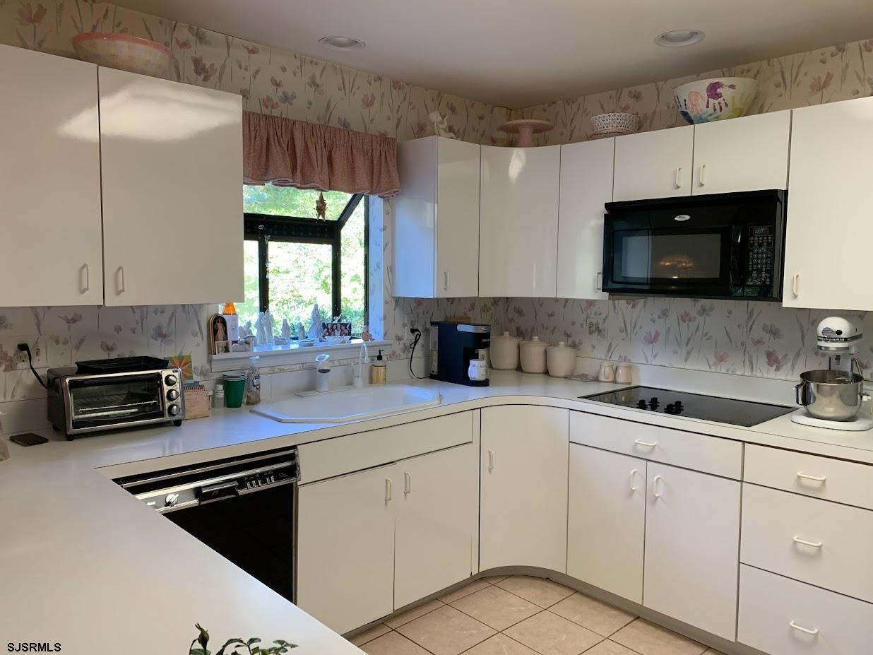 16 Greenbriar Road Marmora, NJ 08223 - Photo 7 of 37 a kitchen with a sink stove and microwave
