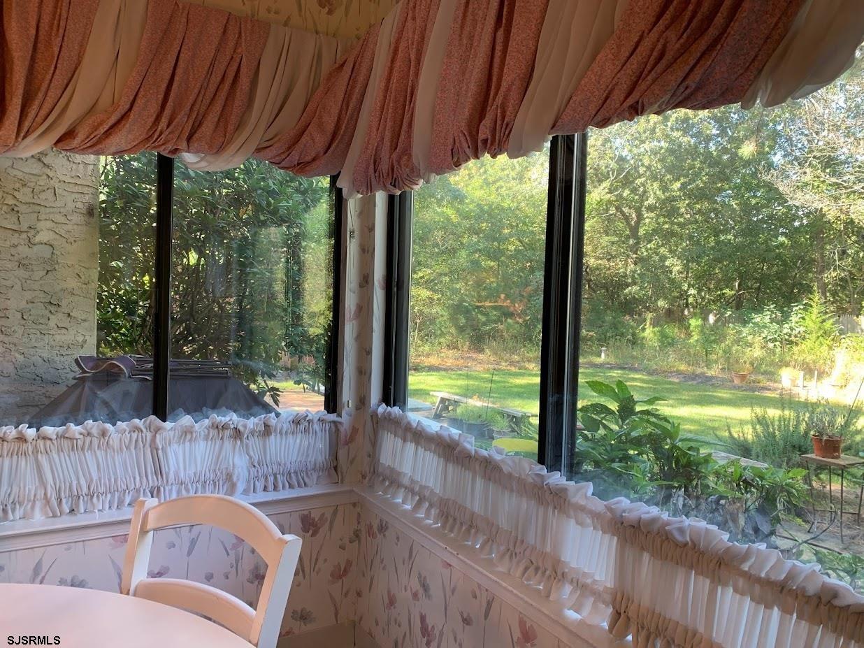 16 Greenbriar Road Marmora, NJ 08223 - Photo 10 of 37 a view of a porch with furniture and garden
