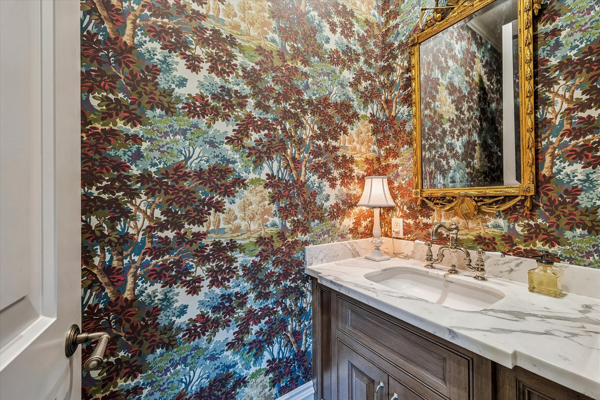 2158 Chilton Road Houston, TX 77019 - Photo 27 of 50 The powder room is richly appointed with designer wallpaper by Bunny Williams for Lee Jofa, elegant lighting, and marble countertops. Thoughtful details and refined finishes create a sophisticated and memorable space for guests.