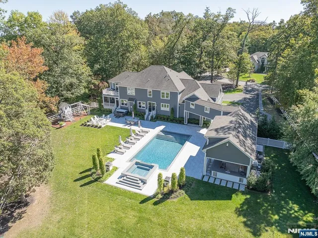 an aerial view of a house with swimming pool garden and patio