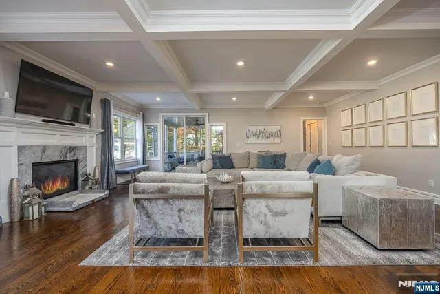 a living room with fireplace furniture and a flat screen tv