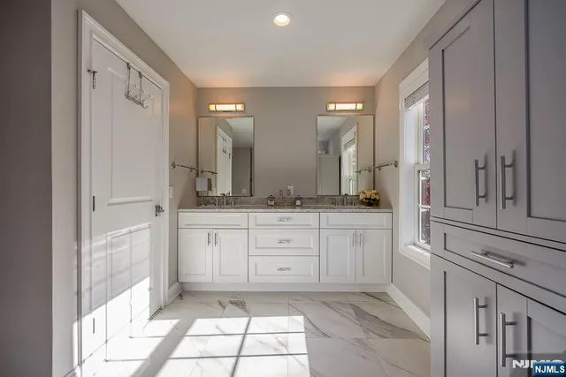 a spacious bathroom with a granite countertop sink mirror and a
