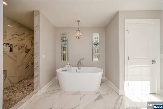 a white bath tub sitting next to a white sink