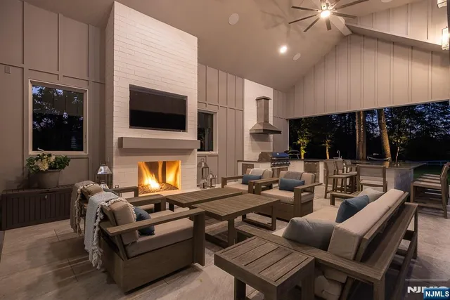 a living room with lots of furniture and a large window