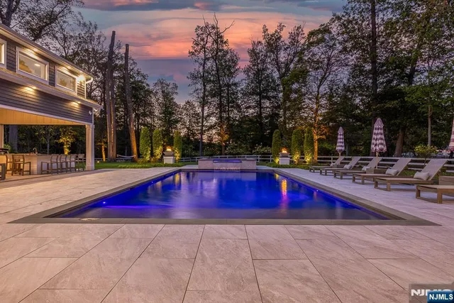 a swimming pool with outdoor seating and yard