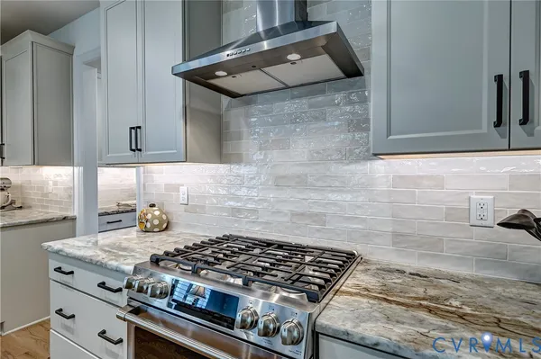 a stove top oven sitting inside of a kitchen