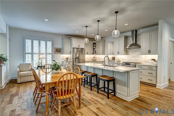 an open kitchen with granite countertop and white cabinets