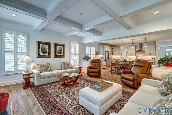 a living room with furniture kitchen view and a window