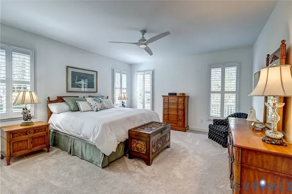 a spacious bedroom with a bed and a dresser