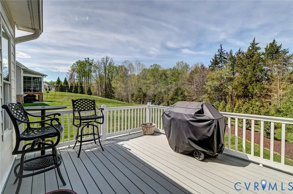 a view of balcony with wooden floor and outdoor seating