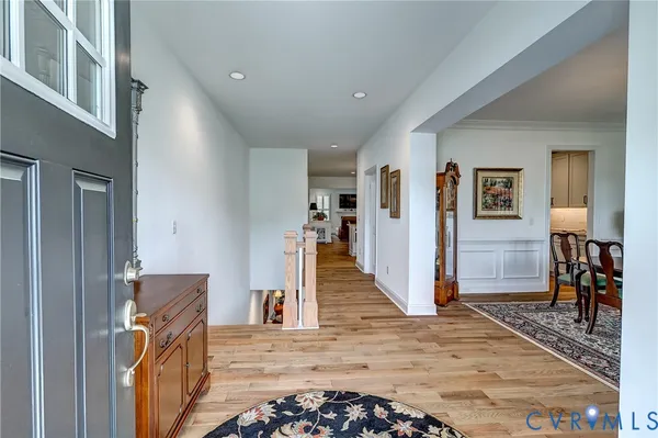 a view of a livingroom with a dinning area hardwood floor and a ceiling fan