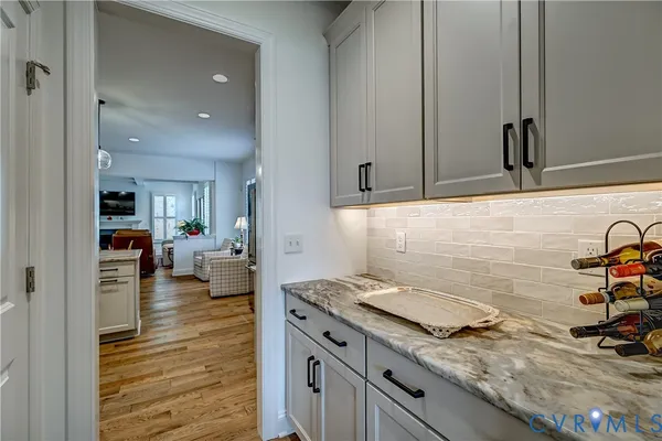 a kitchen with granite countertop a sink and cabinets