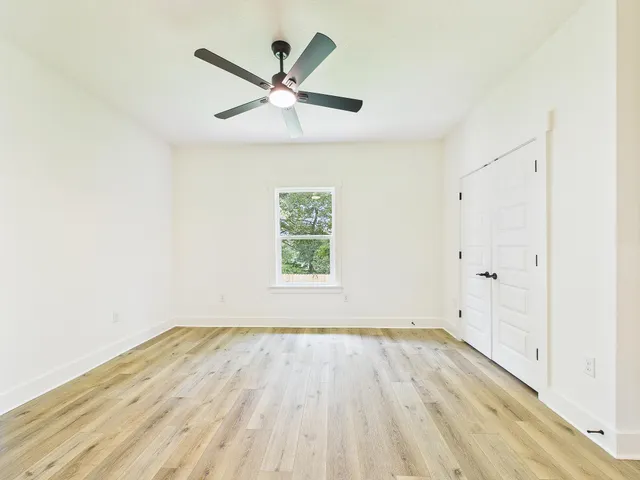 a bedroom with a large bed and a chandelier