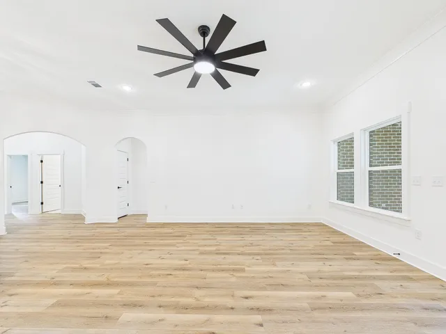 a view of a room with window and ceiling fan