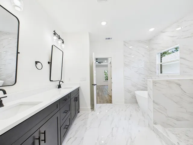 a bathroom with a bathtub and shower