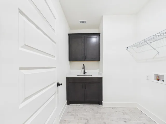 a view of a room with wooden floor and cabinet