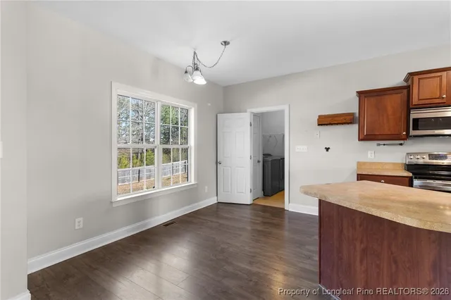 a kitchen with granite countertop a stove and a wooden floor