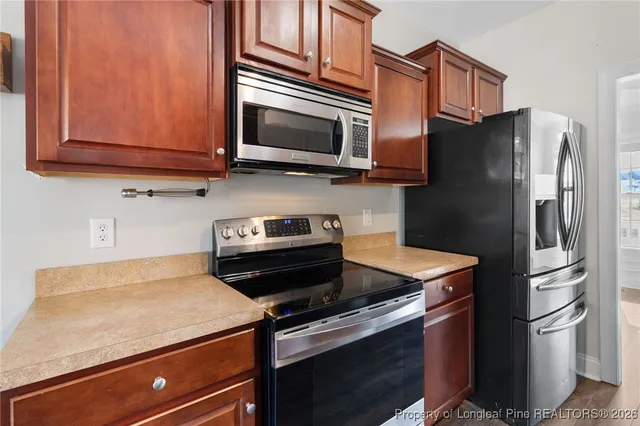 a kitchen with stainless steel appliances and wooden cabinets