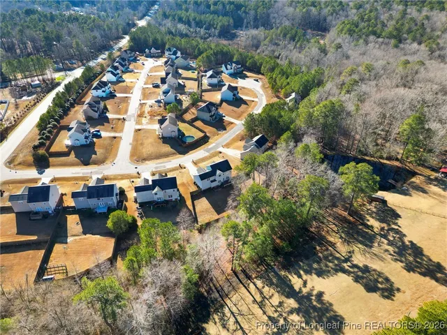an aerial view of a house with yard swimming pool and outdoor seating