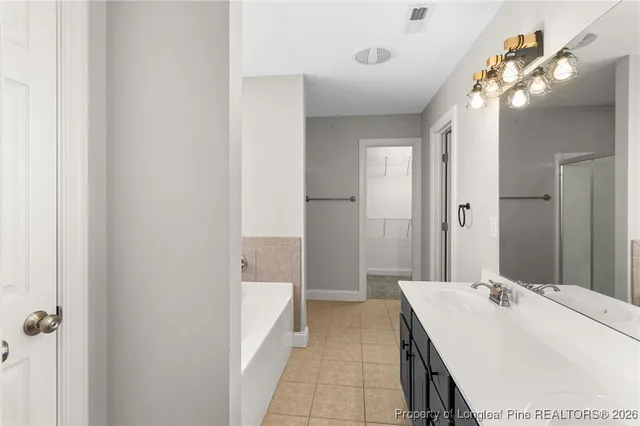 a bathroom with a sink a mirror and a shower