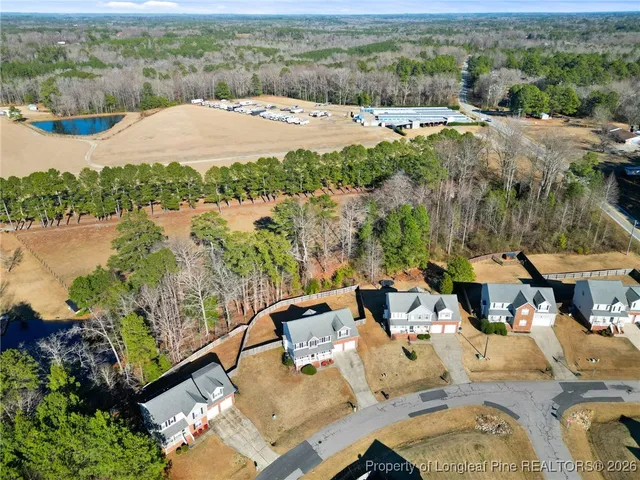 an aerial view of a house with garden space and lake view
