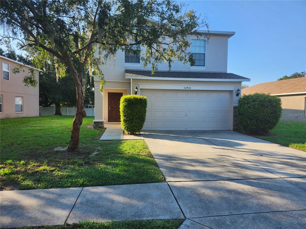 12431 White Bluff Road Hudson, FL 34669 - Photo 1 of 1 a front view of a house with a yard and garage