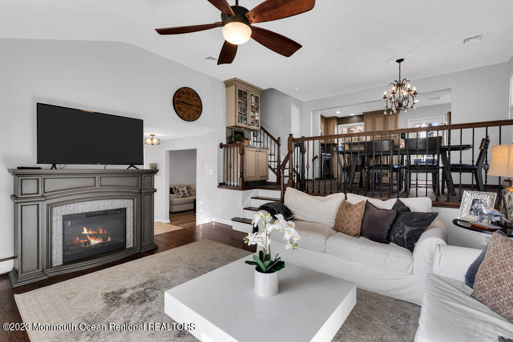 17 Eisele Avenue Asbury Park, NJ 07712 - Photo 24 of 52 a living room with furniture a fireplace and a flat screen tv