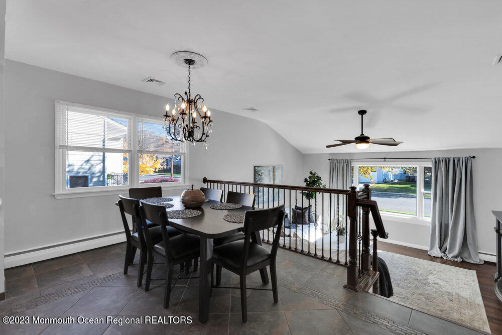 17 Eisele Avenue Asbury Park, NJ 07712 - Photo 29 of 52 a dining room with wooden floor a chandelier a wooden table and chairs