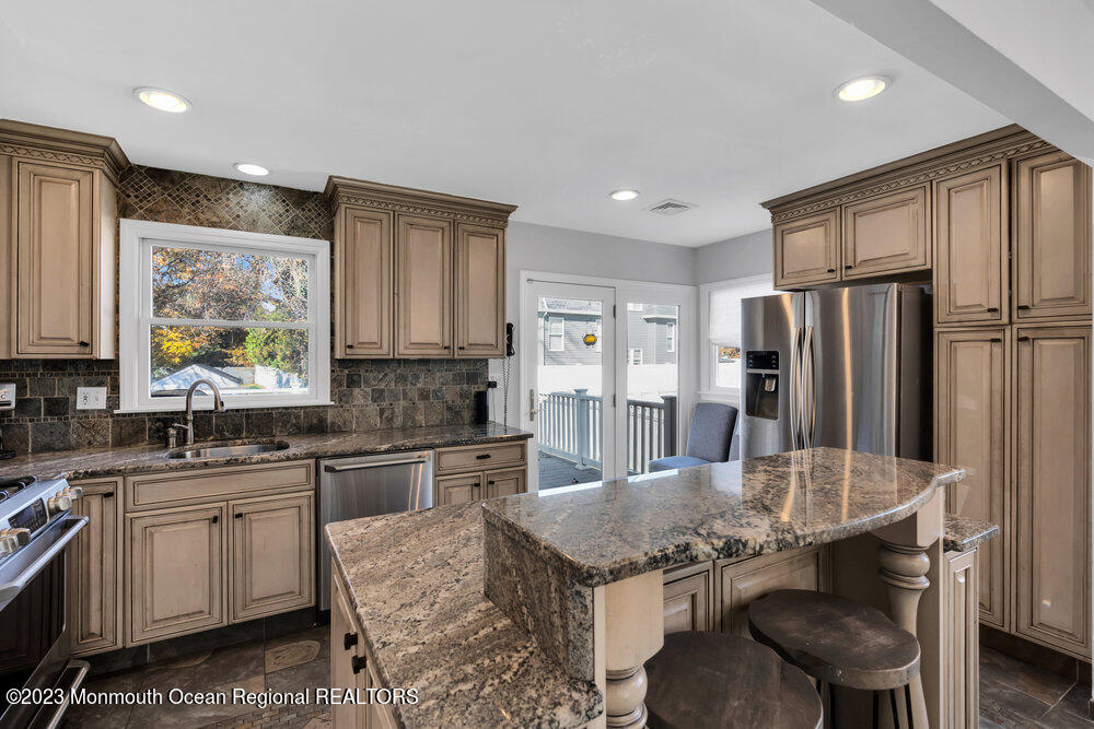 17 Eisele Avenue Asbury Park, NJ 07712 - Photo 33 of 52 a kitchen with stainless steel appliances granite countertop a sink stove and refrigerator