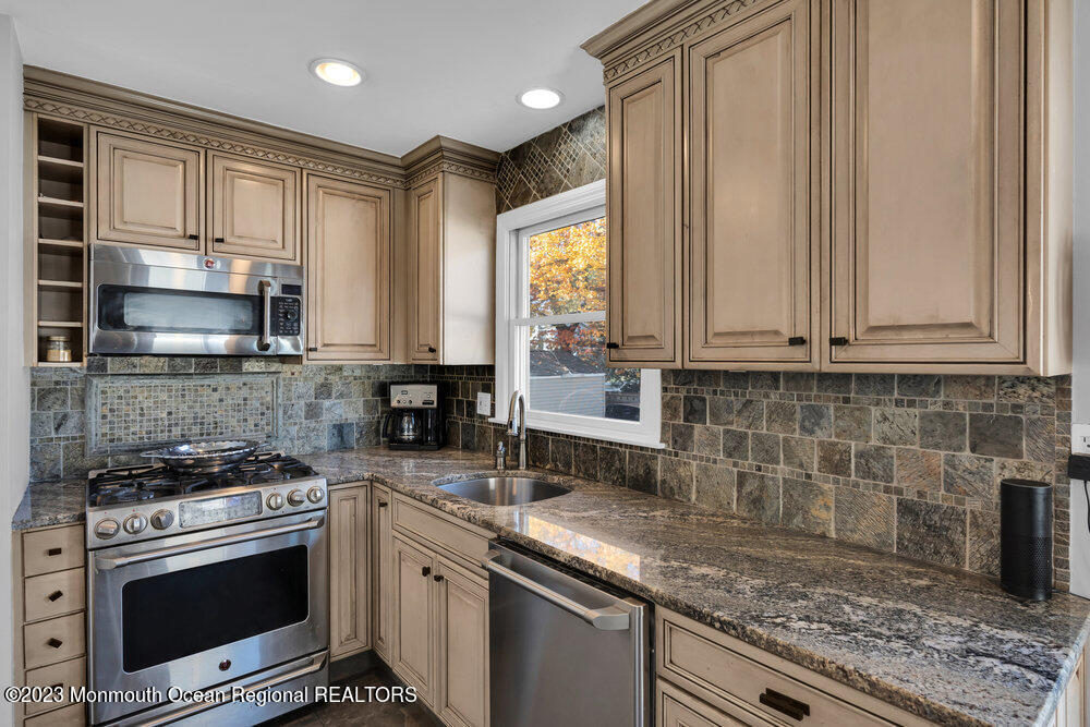 17 Eisele Avenue Asbury Park, NJ 07712 - Photo 35 of 52 a kitchen with stainless steel appliances granite countertop a sink stove and cabinets