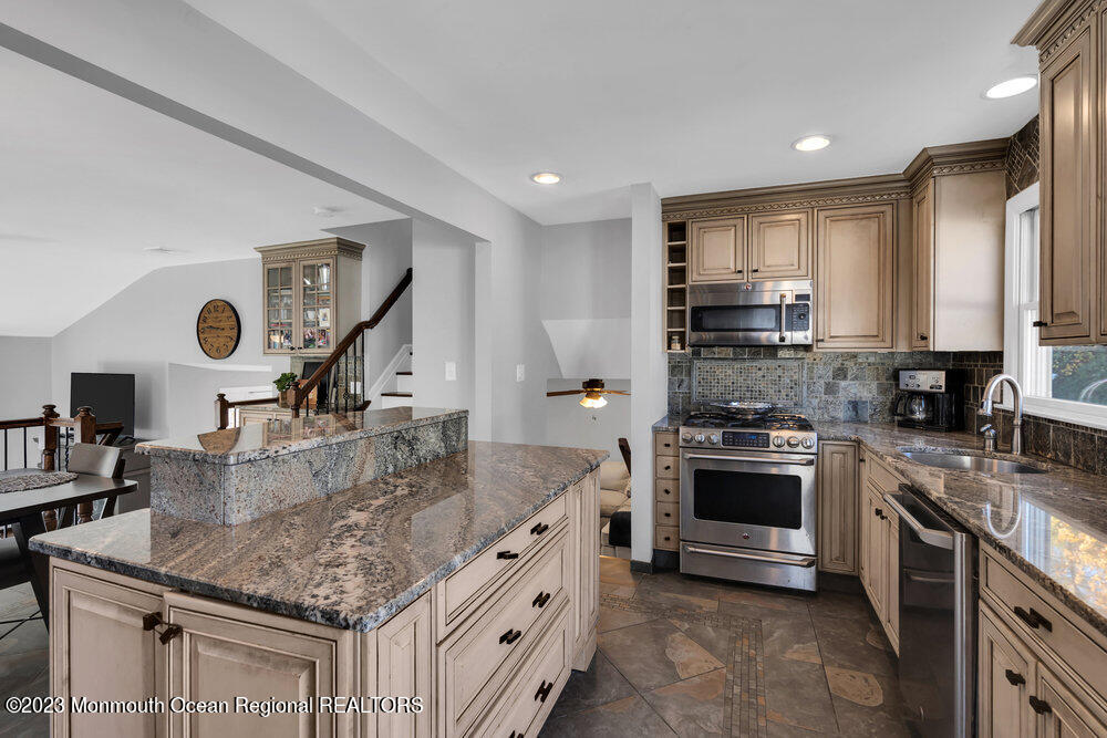 17 Eisele Avenue Asbury Park, NJ 07712 - Photo 38 of 52 a kitchen with stainless steel appliances granite countertop a sink stove and refrigerator