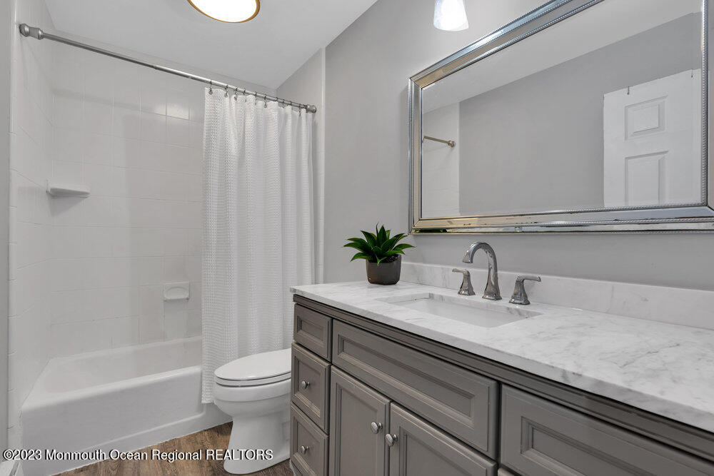 17 Eisele Avenue Asbury Park, NJ 07712 - Photo 39 of 52 a bathroom with a granite countertop sink a toilet and shower