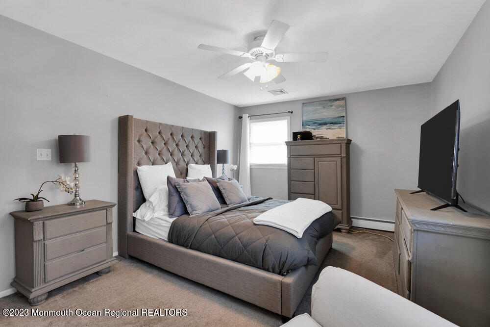 17 Eisele Avenue Asbury Park, NJ 07712 - Photo 43 of 52 a bedroom with a bed and a flat screen tv